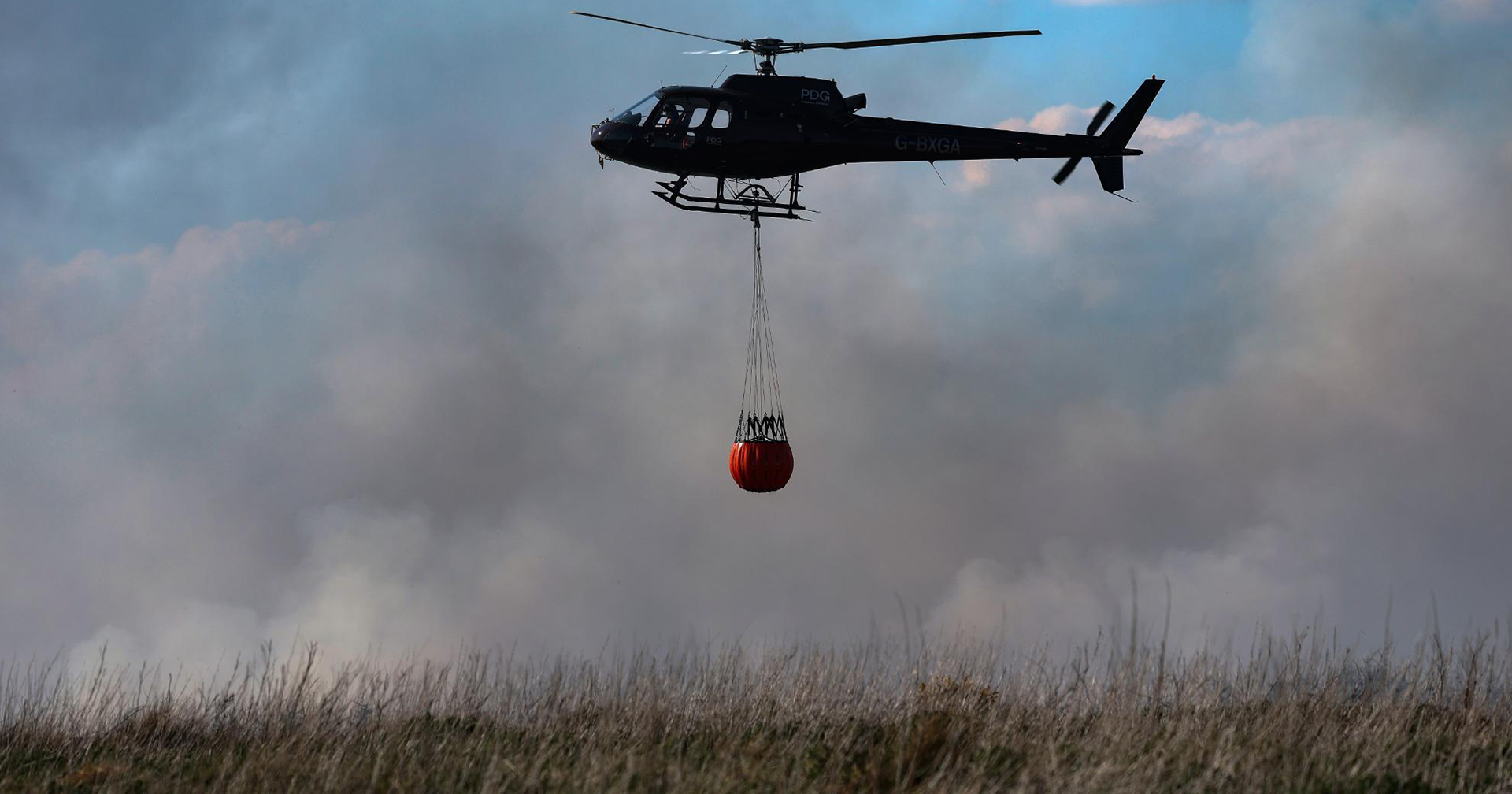 Helicopter seen attempting to extinguish the fire